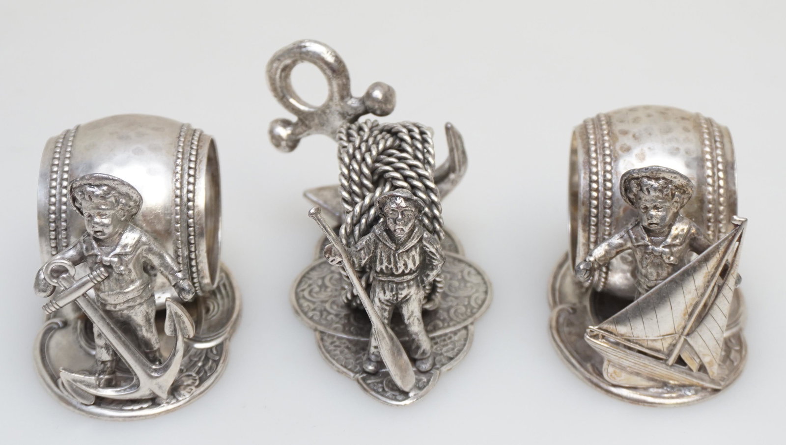 3 FIGURAL SILVERPLATE NAPKIN RINGS: 3 Vintage 20th Century Figural Napkin Rings. Victorian Style after the originals, Silver Plate Napkin Rings all with a nautical theme. No Visible Hallmarks. Great addition to any collection. Largest 3