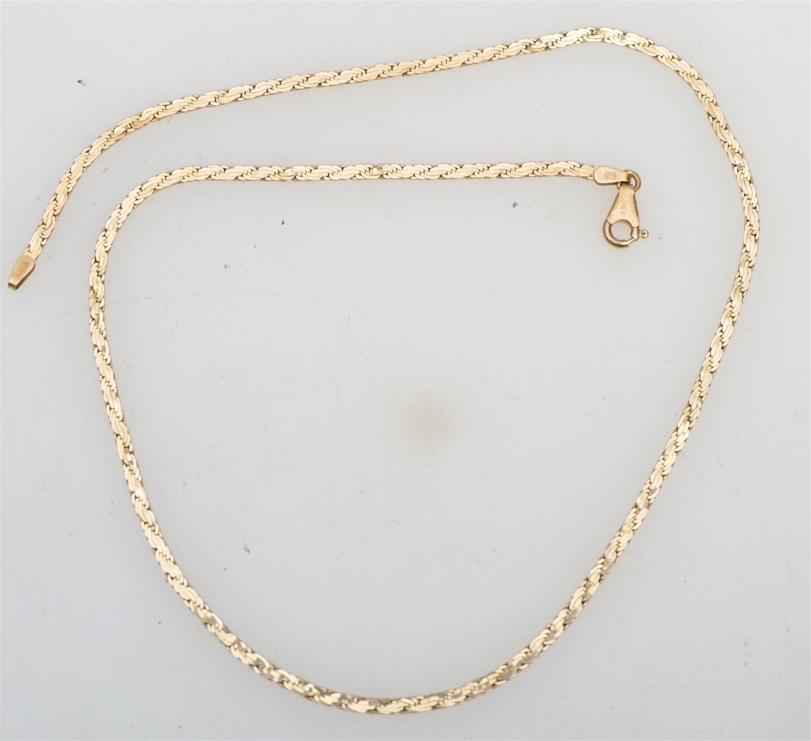 14KT GOLD FLAT WOVEN NECKLACE (8.10 GRAMS): 14kt gold 18.00" flat woven link design necklace. The necklace measures approx. 2.40mm wide, has a high polish finish, a lobster style spring ring clasp and weighs approx. 8.10 grams.