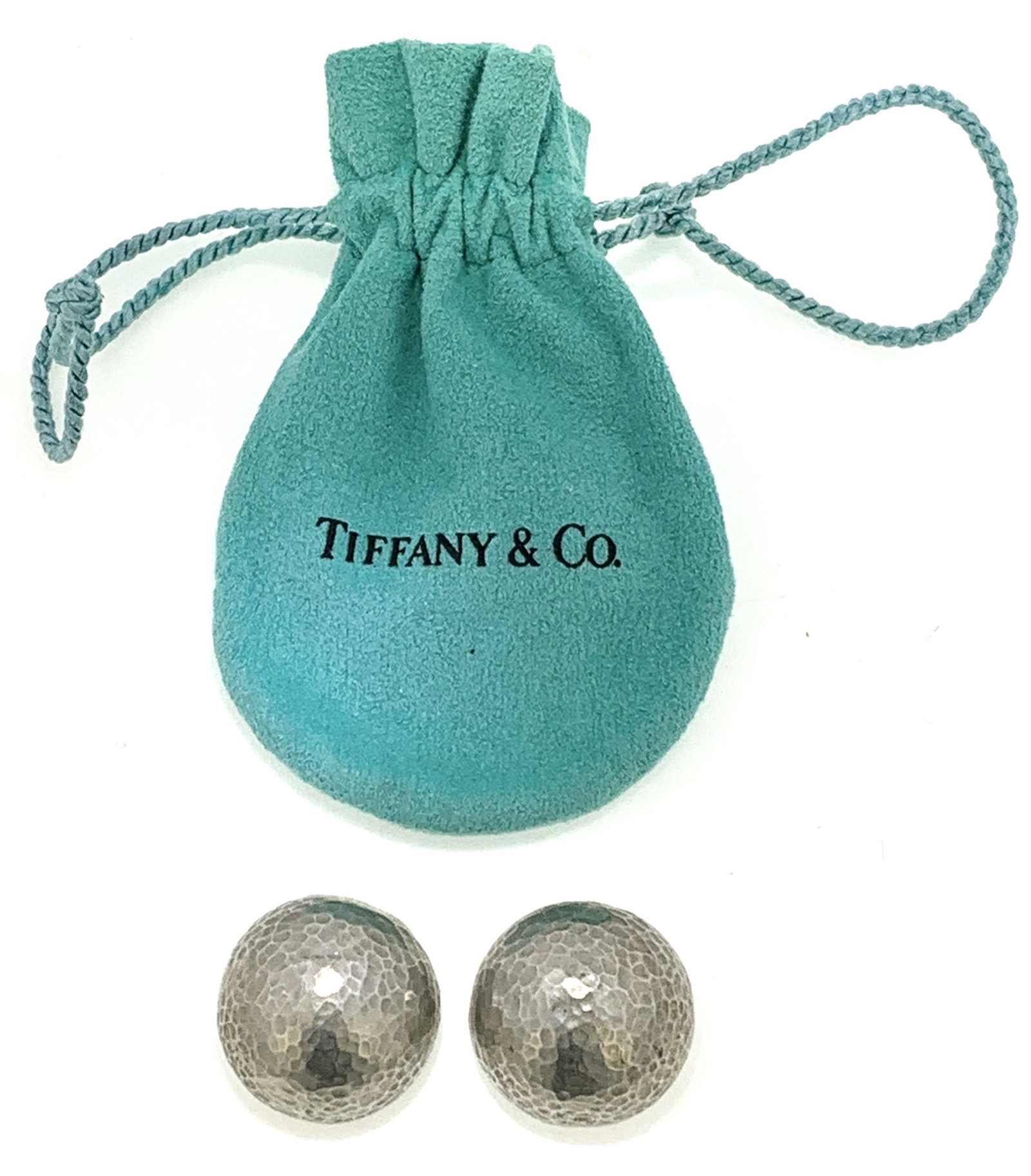 TIFFANY & CO. PALOMA PICASSO EARRINGS (19.60 GRAMS): Pair of Tiffany & Co. Paloma Picasso sterling silver domed hammer earrings in bag. The earrings each measure approx. 1.75" round, have a hammered surface, clip on omega backs, are stamped "Tiffany & C