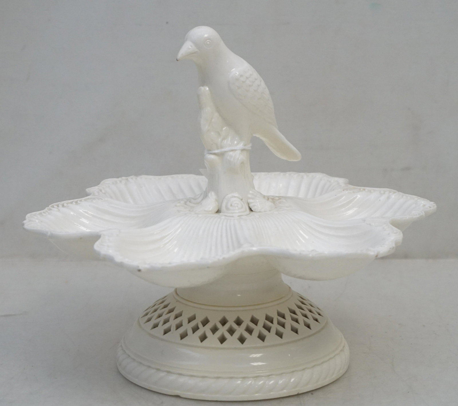 CREAM WARE SEAFOOD / OYSTER SERVER WITH BIRD: Unusual Creamware 6 Section Footed Oyster Seafood Plate with center Bird Handle surrounded by seashells. Reticulated base. Measures 9 1/4"x9 1/4"x8". Weight 1 pd 11 oz.