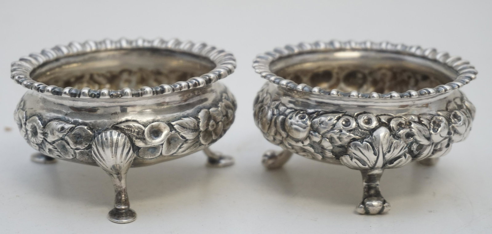 TWO BALTIMORE STERLING REPOUSSE SALT CELLARS: 2 Antique American Quality Sterling Silver Repousse Salt Cellars by the Baltimore Sterling Silver Co. 1894-1904. Each in a different repousse pattern, both monogrammed to base. Silver weight approxima