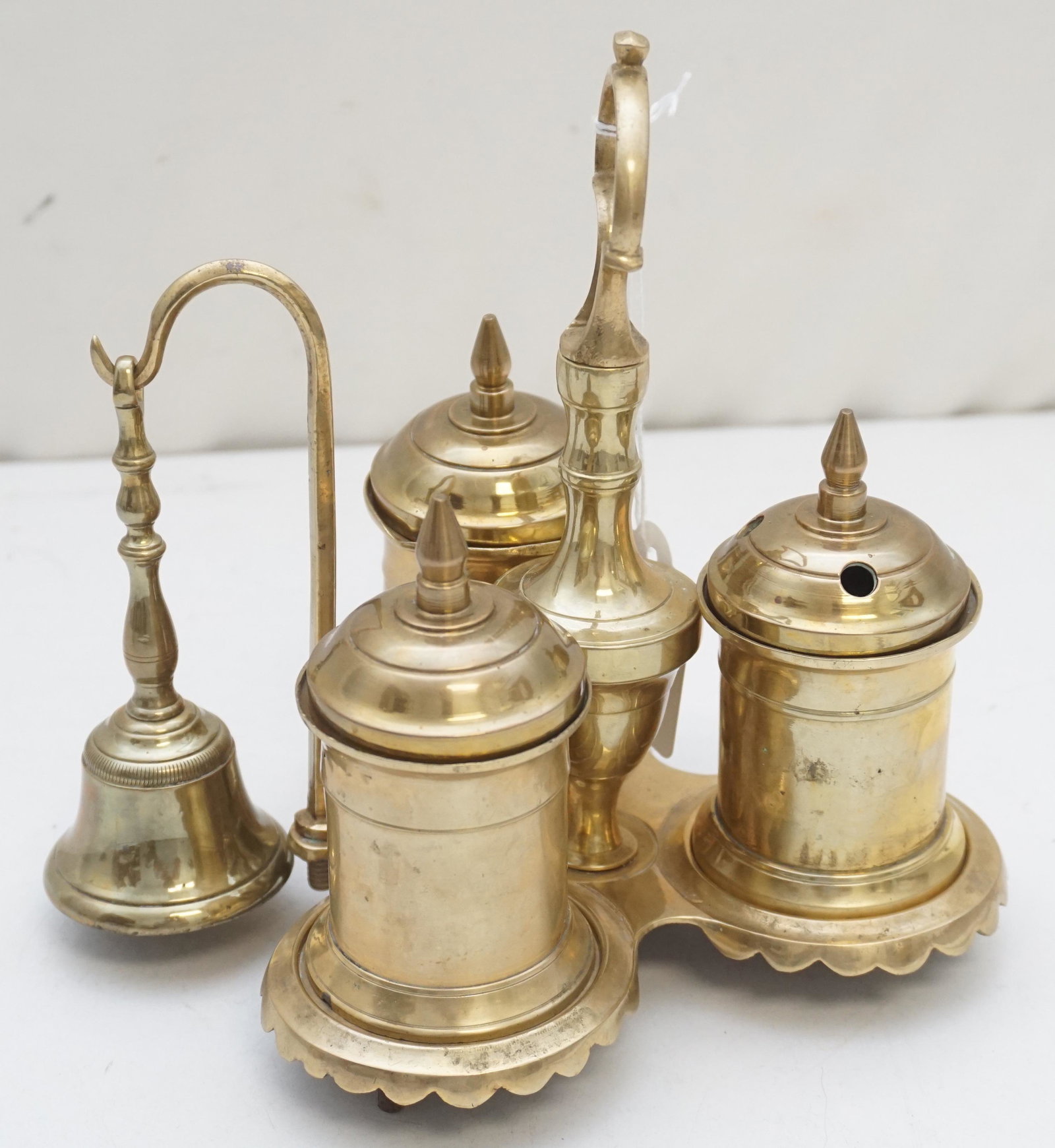 EXCEPTIONAL 19TH C. GEORGIAN BRASS INKWELL / STANDISH: 19th c. English Georgian Solid Brass Inkwell Standish. With lidded inkwell, lidded brass sander, lidded quill holder, brass bell on stand. Measures 7"x6"x7 1/4". Weight 2 pds 3 oz. PROVENANCE: A Priva