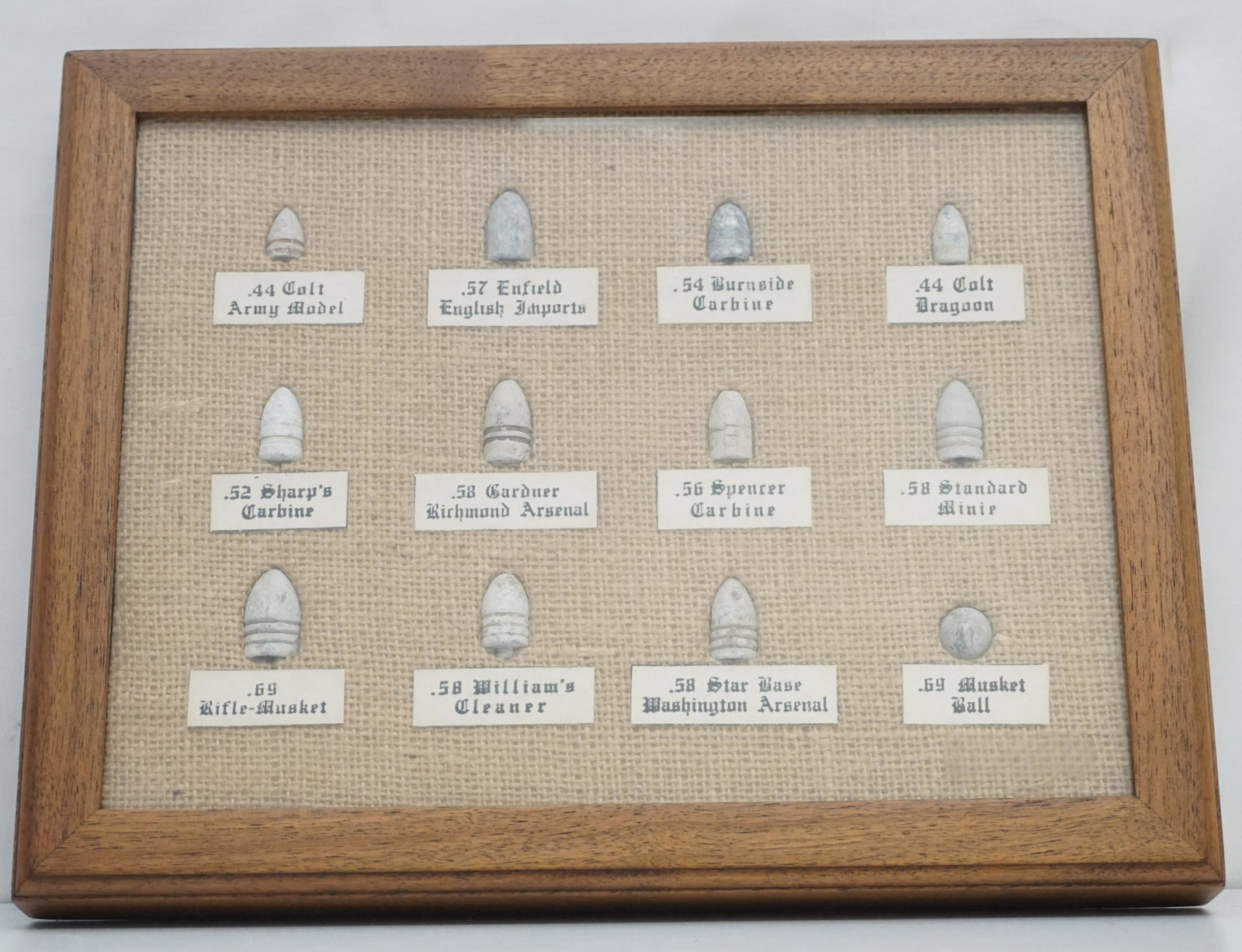 FRAMED GROUP OF CIVIL WAR BULLETS LABELED: Oak Framed Shadow Box Display of Civil War Era Bullets. All labeled. Includes .44 Colt Army Model, .57 Enfield, .54 Burnside Carbine, .44 Colt Dragoon, 52 Sharps Carbine, .58 Gardnet Richmond Arsenal,