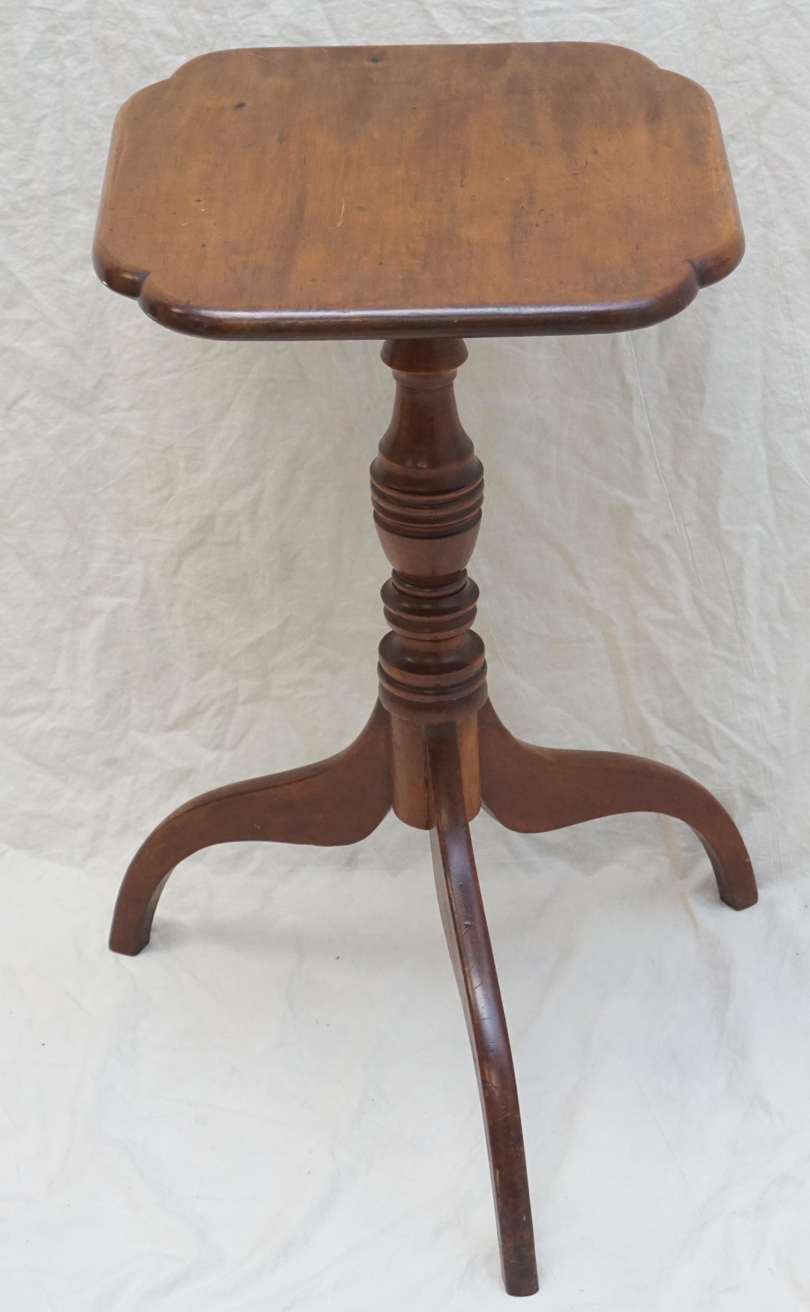 AMERICAN FEDERAL 19th c CANDLESTAND: Antique American 19th c. Federal Birch and Cherry Candlestand with Shaped Top on turned shaft set on tripod base. Measures 16"x15"x26". NO IN HOUSE SHIPPING ON THIS LOT. PROVENANCE: A Private Charlest
