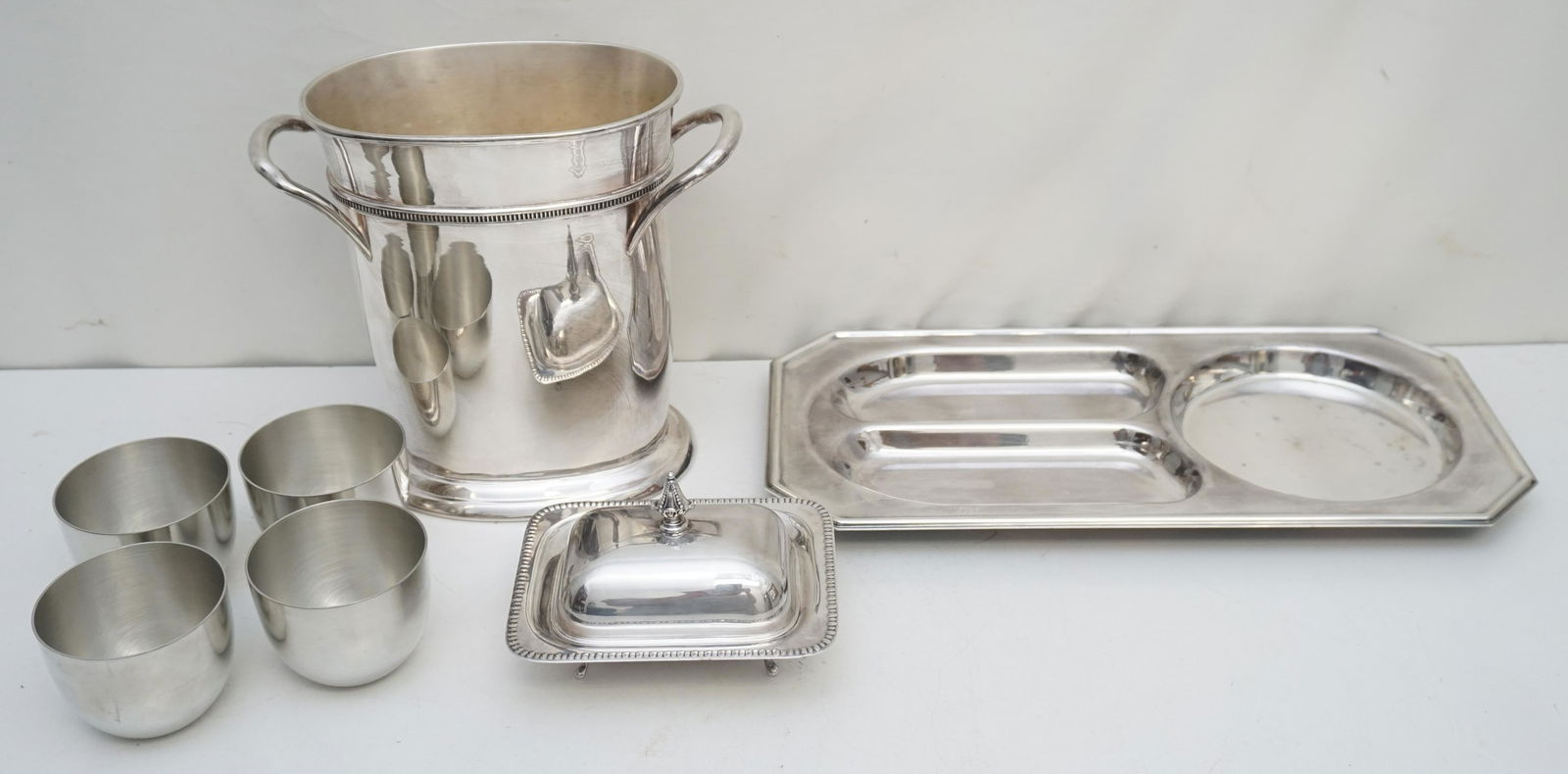 7 PC JEFFERSON PEWTER + SILVER PLATE: 1- (Four) 4 Kirk Stieff Pewter Monticello Jefferson Cups 3 1/2"x2 1/2". 2- Traditional Oval Wine Cooler 9 1/2"x51/2"x8 3/4". 3- Sheffield Silver Plate Relish / Cheese Platter 16"x8". 4- Small Sheffiel