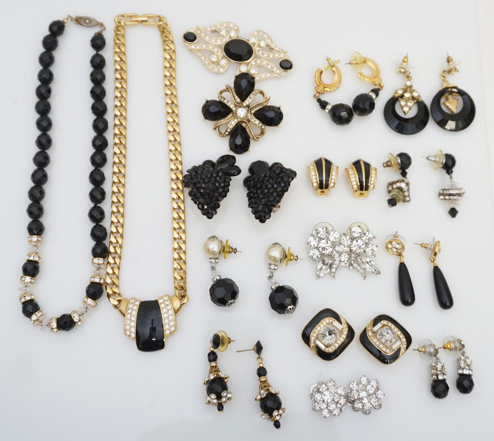 16 pc COSTUME JEWELRY GROUPING - WEISS - MONET +: 16 Piece Costume Jewelry Grouping. To include 2 Necklaces, 2 Brooches, 4 pair Clip On Earrings and 8 Pair or Pierced Earrings. Makers include Christian Dior, Weiss, Monet, Trifari and unmarked. Weight