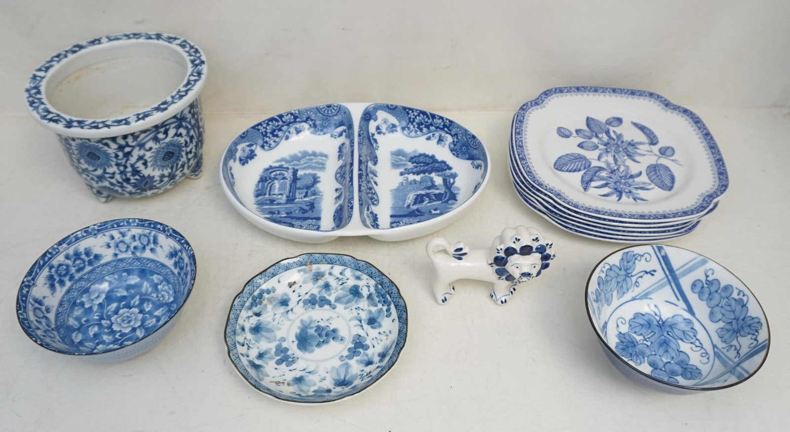GROUPING BLUE & WHITE PORCELAIN: All are 20th c. Blue and White Porcelain. 6 Spode Blue Room Dishes 9". Spode Italian Pattern Divided Dish 12" long. 3-2 Asian Bowls 6". 4- Asian Plate 6". Asian Planter 5". Russian Lion 4 1/2". Weight
