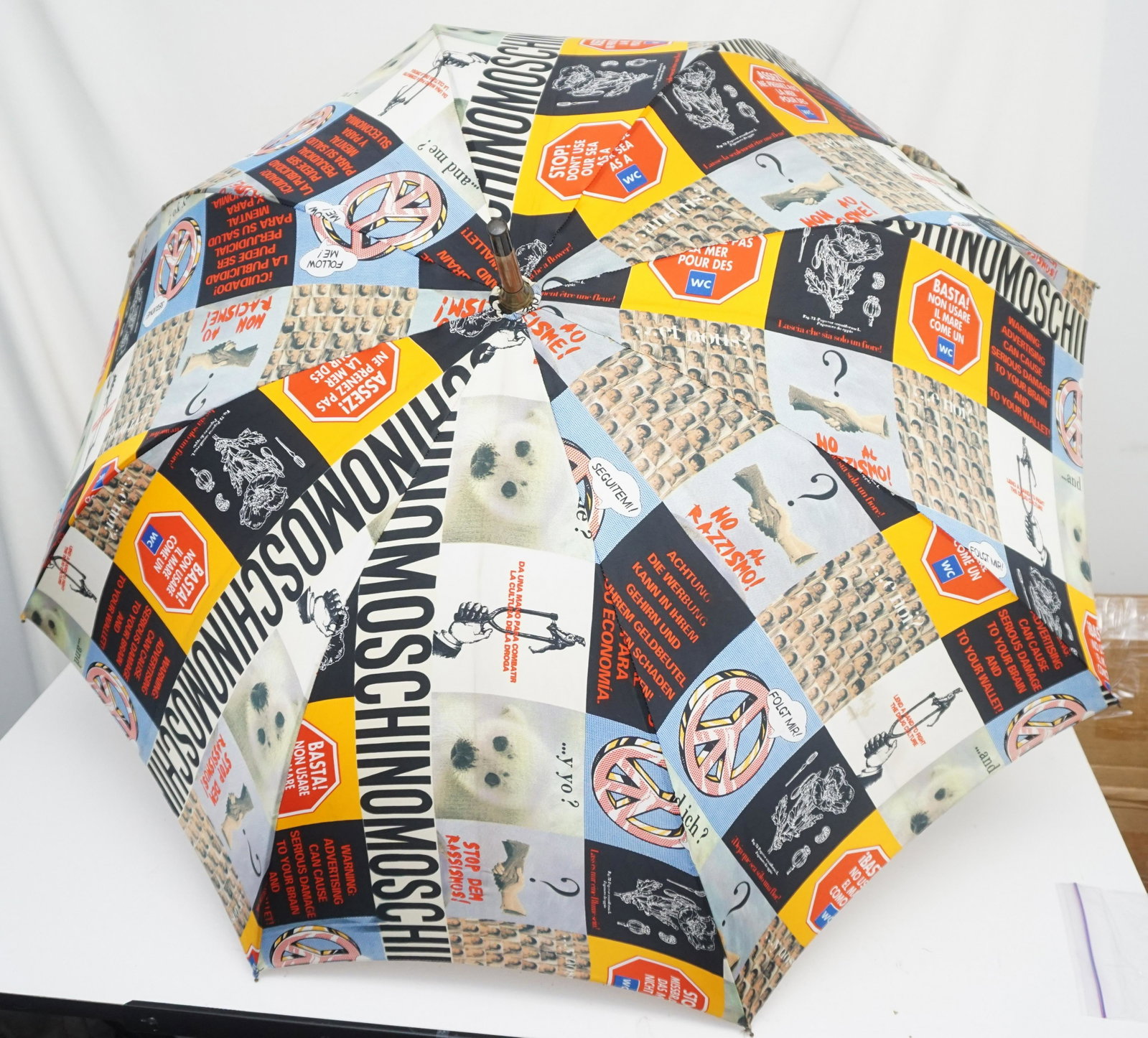 VINTAGE MOSCHINO FASHION UMBRELLA: Moschino Fashion Umbrella, 36" when Opened. Handle signed giornata bagnata, giornata fortunata. Measures 38" Long. Weight 1 pd 10 oz. PROVENANCE: A Private Charleston SC Estate.