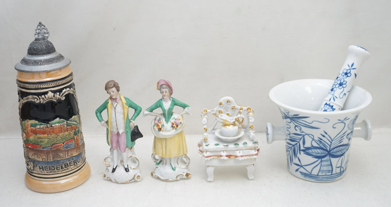 5 PC ANTIQUE & VINTAGE PORCELAIN / STONEWARE: 1- Antique Victorian Fairing Box, some wear 2 1/4"x3"x4 1/2". 2- West Germany Heidelberg Stein 9". 3- Handgemalt Mortar 4 1/2 & Pestle 7" 4&5- Pair of German Man and Woman Figurines, each 6". Weight o