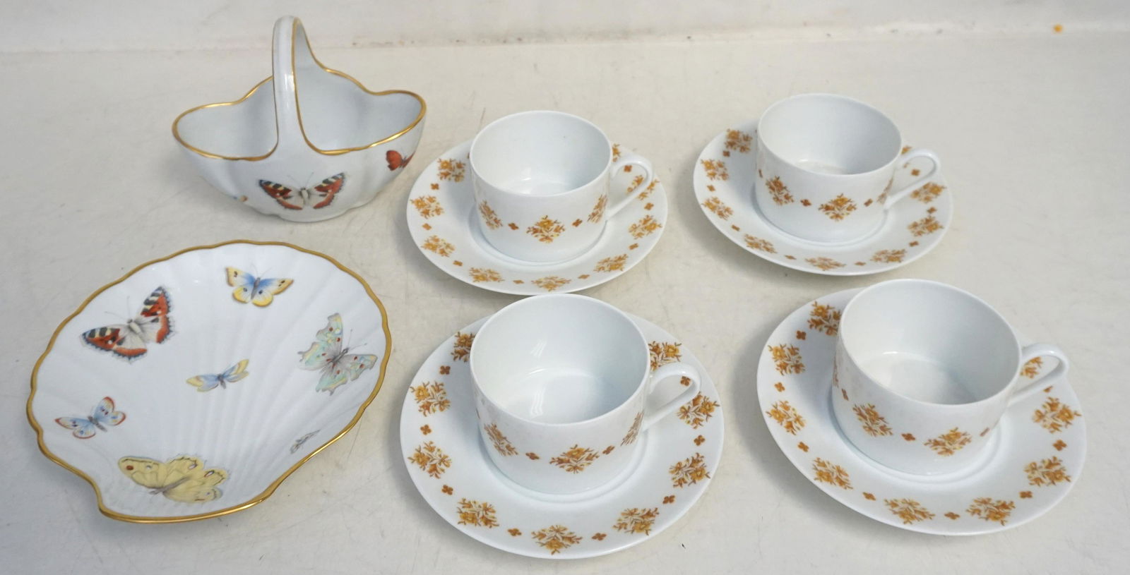 10 PC LIMOGES FRANCE BUTTERFLY AND FLORAL PORCELAIN: 1- Vintage 8 Piece Cup and Saucer Set, Limoges-France Georges Boyer Porcelaine made exclusively for Marcel Rochas. Saucers 5 1/2". Cups 3" wide. 2- Limoges France Butterfly Basket 5 1/2" long. 3- Limo