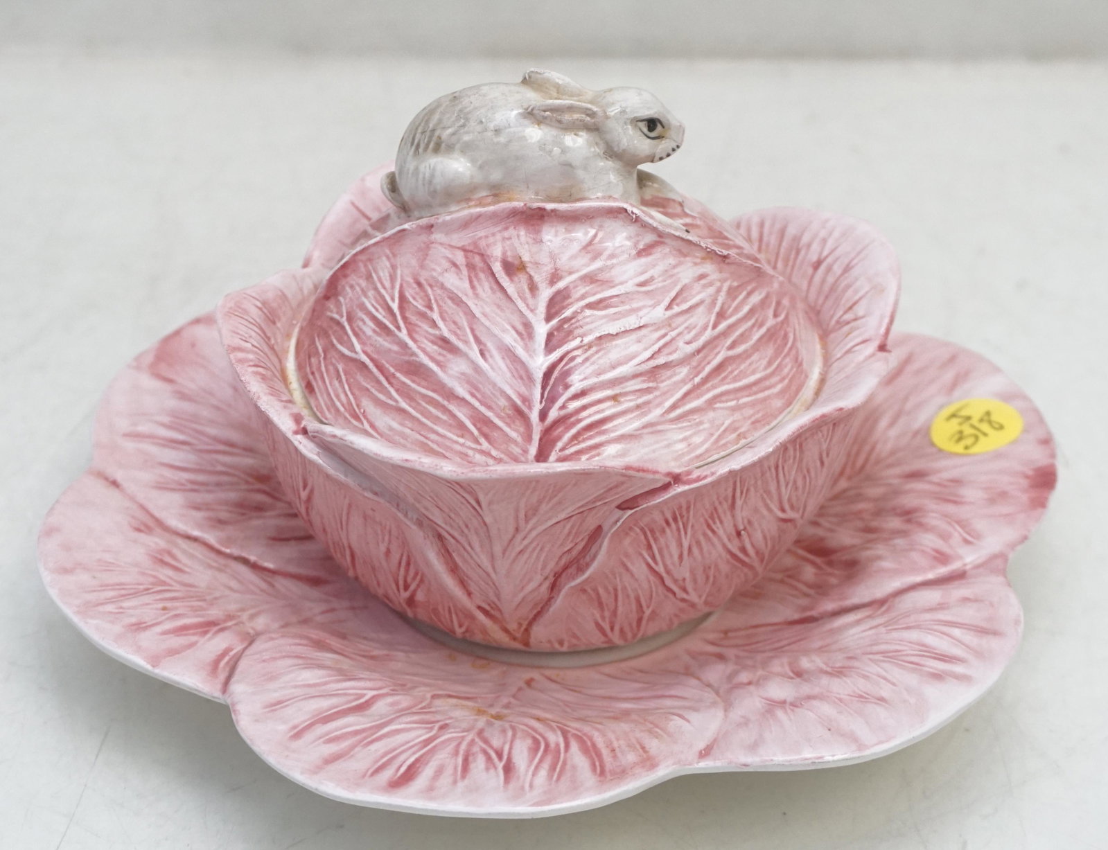 MOTTAHEDEH ITALIAN PINK CABBAGE RABBIT BOWL: Vintage Mottahedeh Italian Ceramic Pink Cabbage Covered Bowl with Bunny Rabbit Finial and Cabbage Leaf Underplate. Underplate 8"x8". Dish 5 1/4"x5 1/4"x 4 1/2". Weight 1 pd 6 oz. PROVENANCE: A Private