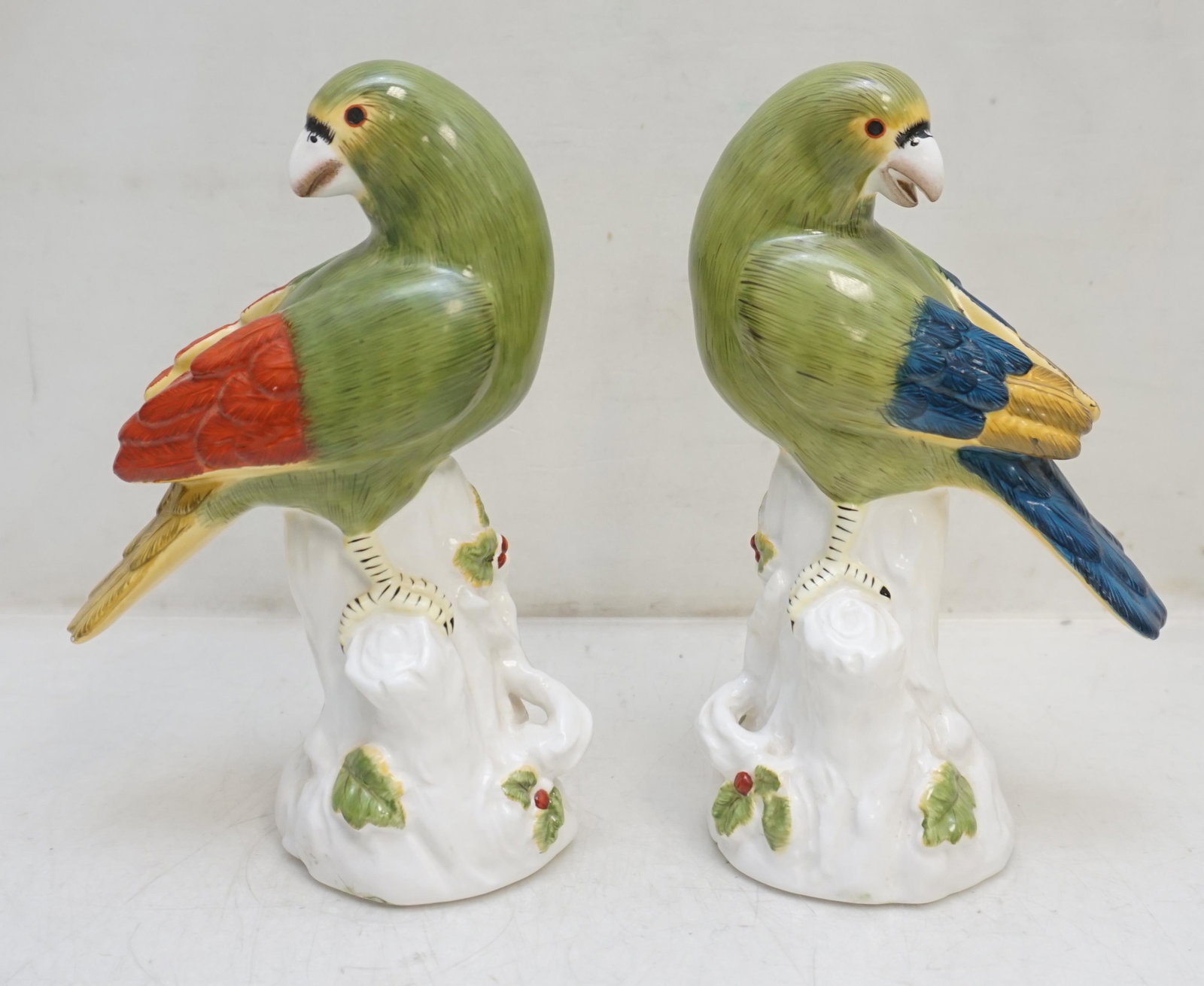 PAIR CHARLESTON HISTORIC FOUNDATION PARROTS: A pair of hand painted parrot figurines by Jeanne Reed’s. The figurines are from the Historic Charleston Foundation line and feature two colorful parrots in vivid green with feathered details in war