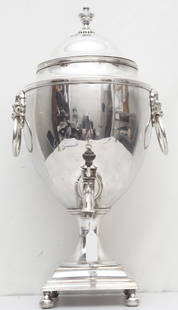 LARGE ANTIQUE SILVER PLATE HOT WATER/ COFFEE URN: Large English Sheffield Silverplate Hot Water Urn with Lion Head Handles raised on 4 ball feet. Urn Finial. Maker unknown.Measures 12"x9"x19". Weight 8 pds. Small dings. PROVENANCE: The Estate of Dr.