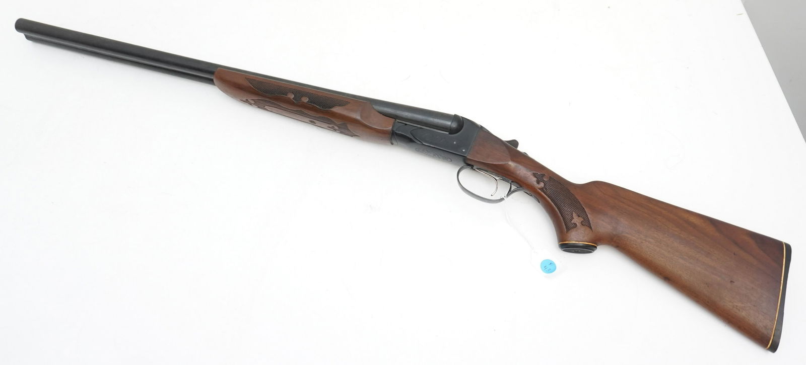 FOX MODEL B 12 GAUGE SIDE BY SIDE SHOTGUN: Vintage Fox Model B 12 gauge side by side shotgun. Walnut stock with checkered grips. Approximately 42" long. NO IN HOUSE SHIPPING ** The buyer of this lot must follow all Federal, State and Local law