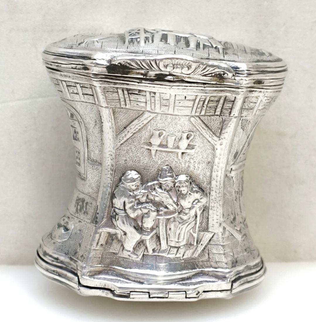 GERMAN SILVER DOUBLE SIDED SNUFF 19th c.: Late 19th c. Hanau Silver Double-Sided Snuff Box by Georg Roth & Company. The snuff of spool form, the sides decorated with peasants smoking pipes, drinking and playing music in a 17th century interio
