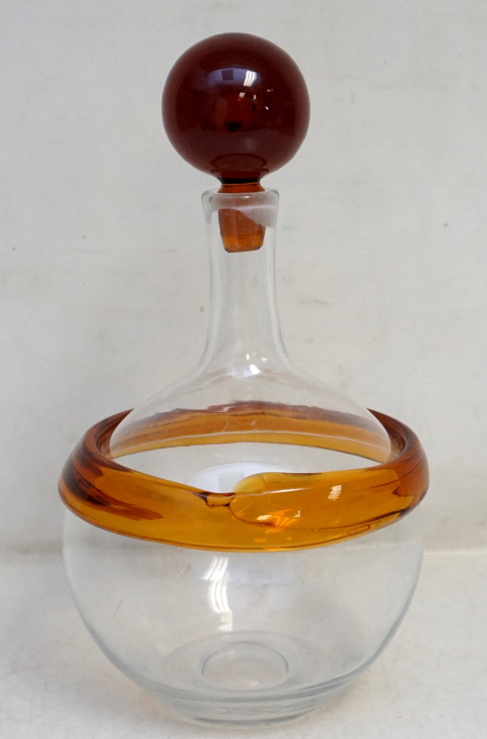 JOEL PHILIP MYERS SIGNED BLENKO DECANTER: Mid Century Joel Philip Myers Signed Blenko Glass Decanter. Amber applied ring and hard to find original stopper. Measures 6"x6"x11 1/2". Weight 2 pds 10 oz. A graduate of the College of Ceramics at A