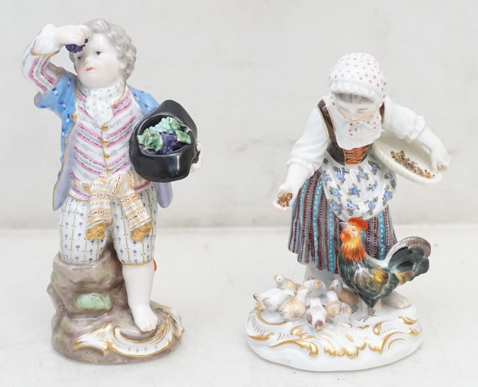 2 MEISSEN PORCELAIN CHILDRENS FIGURES: 2 Meissen Porcelain Figures. Girl Feeding Chickens and Boy Picking and Eating Grapes. Girl 4 1/2". Boy 5". Weight 1 pd 2 oz. PROVENANCE: The Estate of Dr. Fraser Wilson, Charleston SC. Dr. Wilson will
