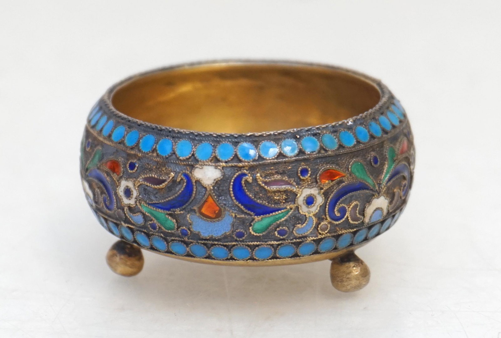 IMPERIAL RUSSIAN SILVER ENAMEL SALT CELLAR: Antique Imperial Russian silver and polychrome enamel cauldron salt on three ball feet with profuse cloisonne decoration c. 1900. Kokoshnik mark to base. Measures 2". Approximate silver weight 25 gram