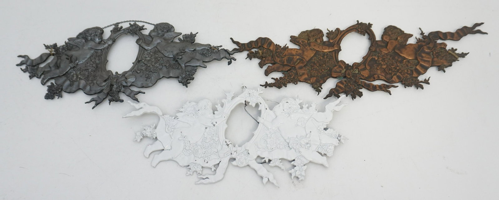 3 VICTORIAN METAL FRAMES / HEADSTONE ACCENTS: 3 Victorian Era German Cherubs Plaque Frames / Headstone Decoration. Photograph would go in the center. Each 13 1/2". Weight on all 1 pd 12 oz. PROVENANCE: A Private Charleston SC Estate.