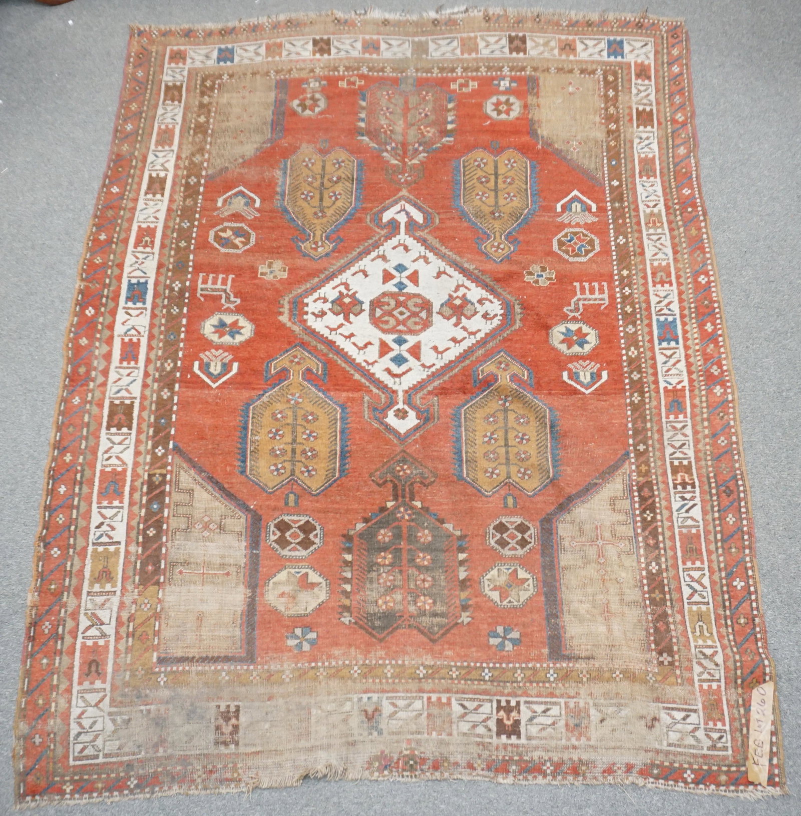 ANTIQUE CAUCASIAN KAZAK RUG 8 FT: Antique Hand Knotted Tribal Caucasian Kazak Rug c. 1900. Approximately 8 feet by 6 feet, Wear to some areas. * NO IN HOUSE SHIPPING. PROVENANCE: A Private Charleston SC Estate. ***Pickup only or Shipp