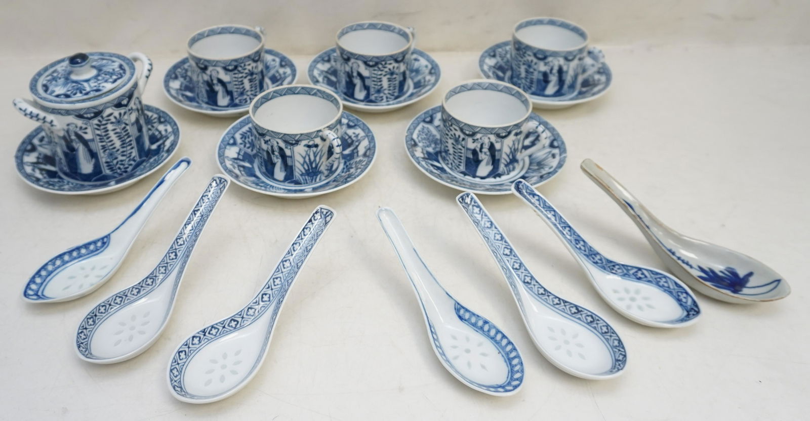19 PC CHINESE BLUE & WHITE TEA CUPS - SPOONS: 19 Piece Chinese Export Blue & White Porcelain. 5 cups 2" and 6 matching saucers 5", 1 matching sugar 3 3/4". 7 Spoons, 6 in the rice grain pattern and 1 19th c. all approximately 5 3/4". Weight on al