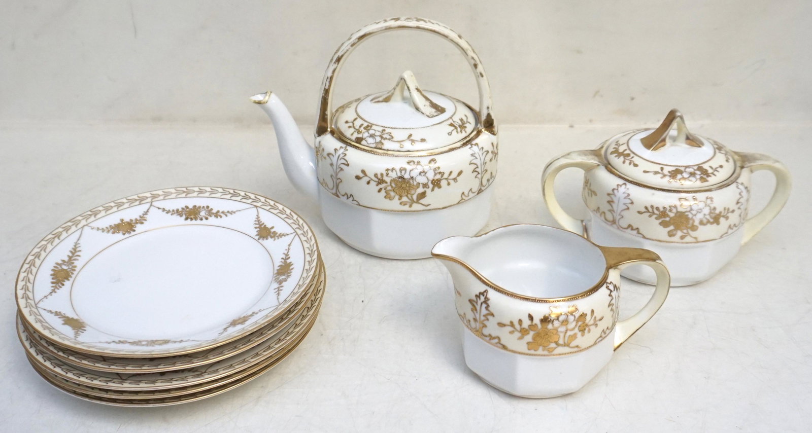8 PIECE HAND PAINTED NIPPON TEA SET: 8 Piece Hand Painted Nippon Tea Set c. 1920-30. With the Maruki Symbol used from 1912. Van Patten’s #180. Some wear to gilt. Teapot 6 1/4" tall. 5 dessert plates 6 1/2". Weight on all 4 pds 3 oz. PR