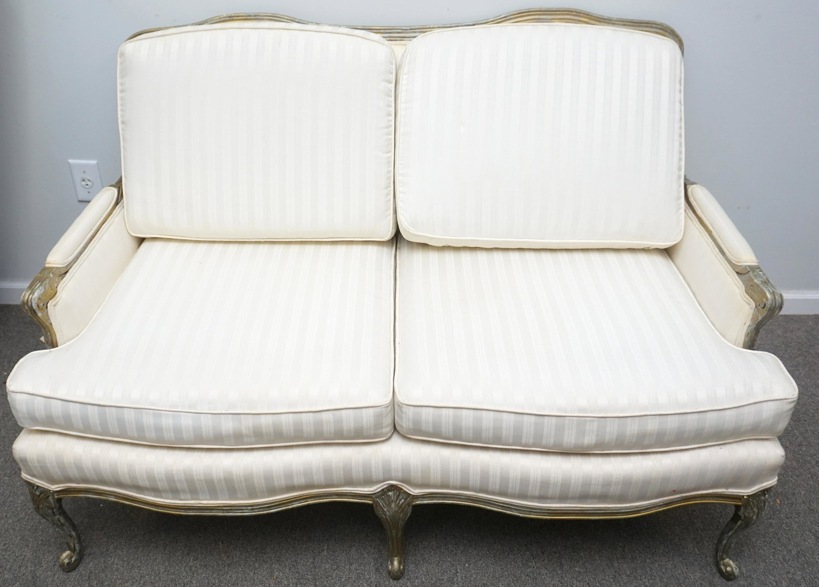 LOUIS XVI STYLE CARVED & GILT SETTEE: Louis XVI Style Carved and Gilt Settee. Cream Brocade Upholstery. Wear to gilt and upholstery. Measures 51 1/2"x28 1/2"x35". NO IN HOUSE SHIPPING. PROVENANCE: A Private Charleston SC Estate.***Pickup 