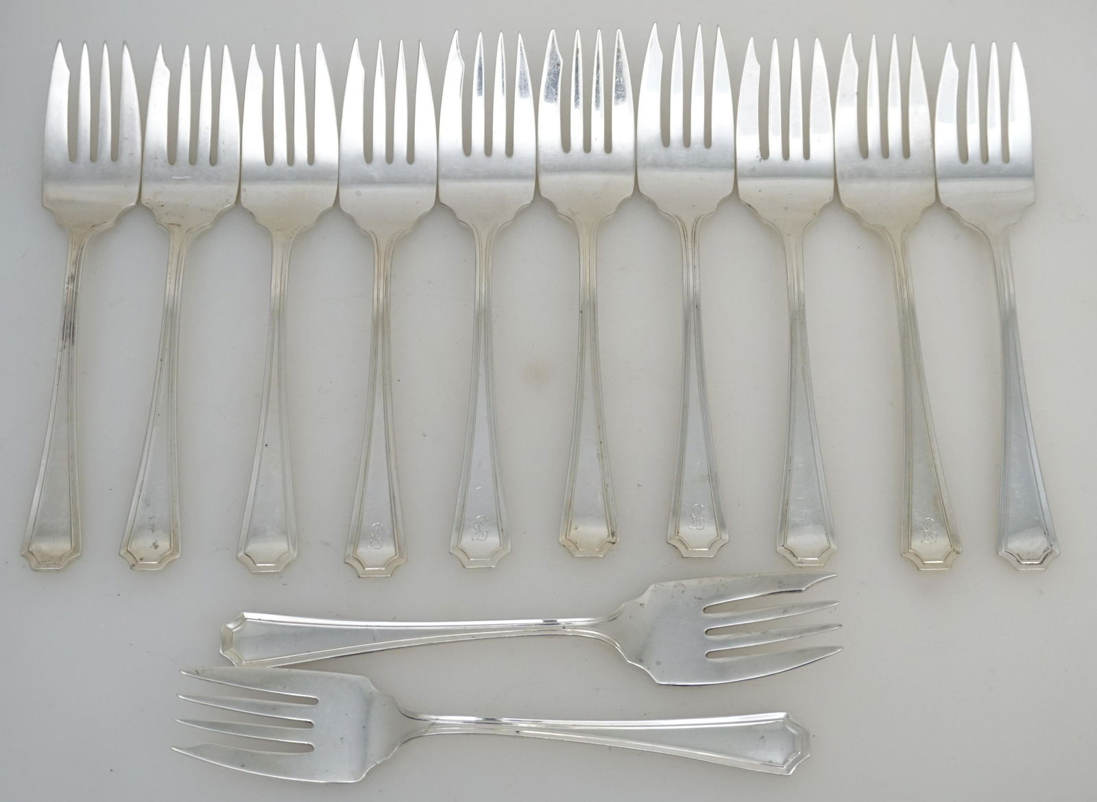 12 STERLING SILVER "FAIRFAX" SALAD FORKS GORHAM: Twelve (12) American Sterling Silver Individual Salad Forks in the 1910 Fairfax Pattern by Gorham, 8 with no monograms and 4 monogrammed. Each 6 1/4". Approximate silver weight 430 grams. PROVENANCE: