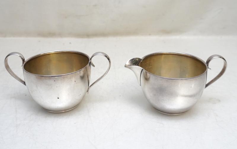 AMERICAN STERLING SILVER CREAM AND SUGAR: Vintage American Sterling Silver Cream and Sugar by Alvin. Creamer 4 1/2" long 2" tall. Sugar 5" long 2 1/4" tall. Approximate silver weight 175 grams. PROVENANCE: A Private Charleston SC Estate.