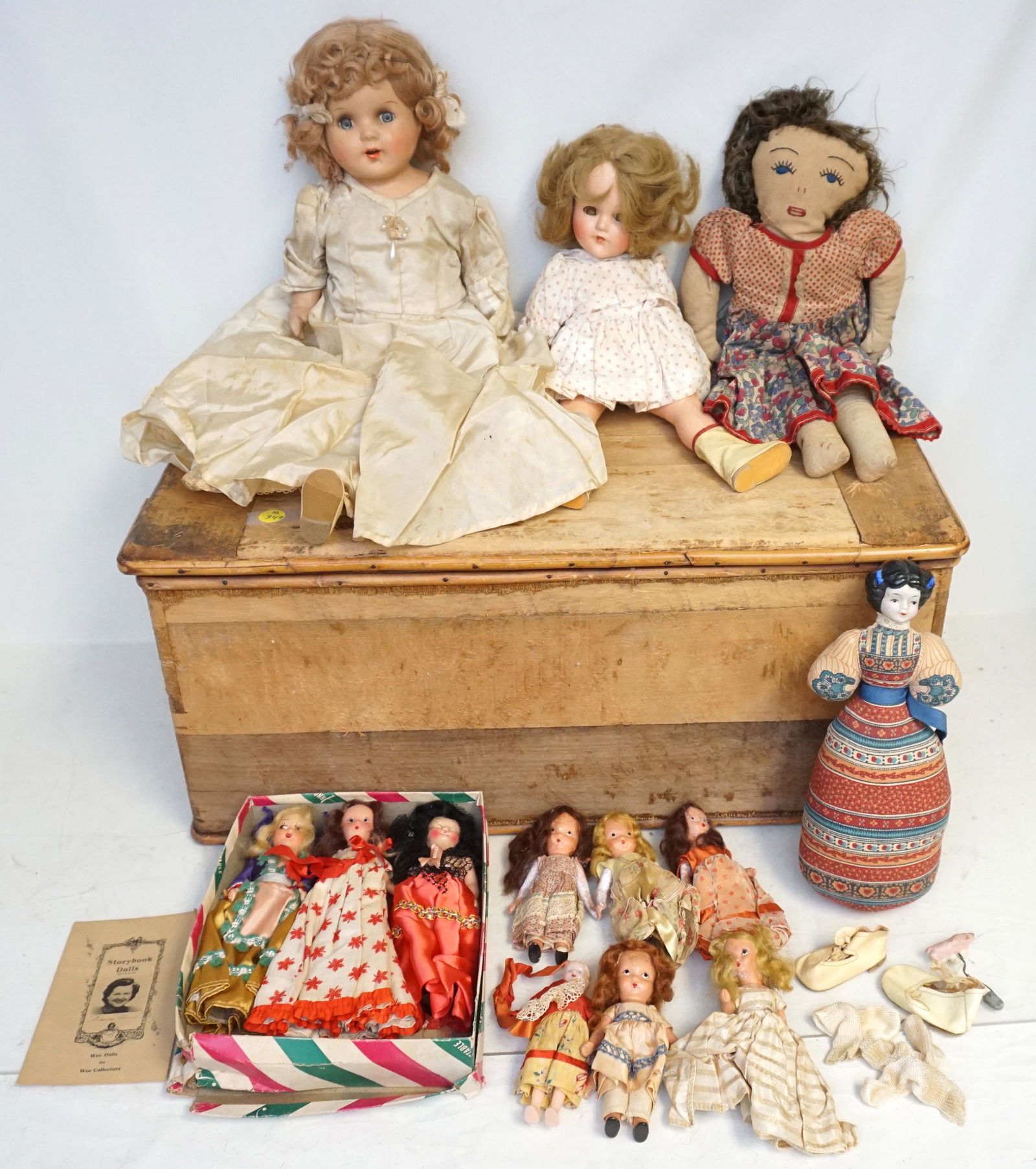ANTIQUE DOLL TRUNK FULL OF DOLLS: Antique Doll Trunk full of Antique and Vintage Dolls and Clothing. All with some wear..1 Effanbee Shirley Temple Doll 15, 7 Storybook Dolls, 1 Small Celluloid Doll. 1 American Heirloom China Head Doll