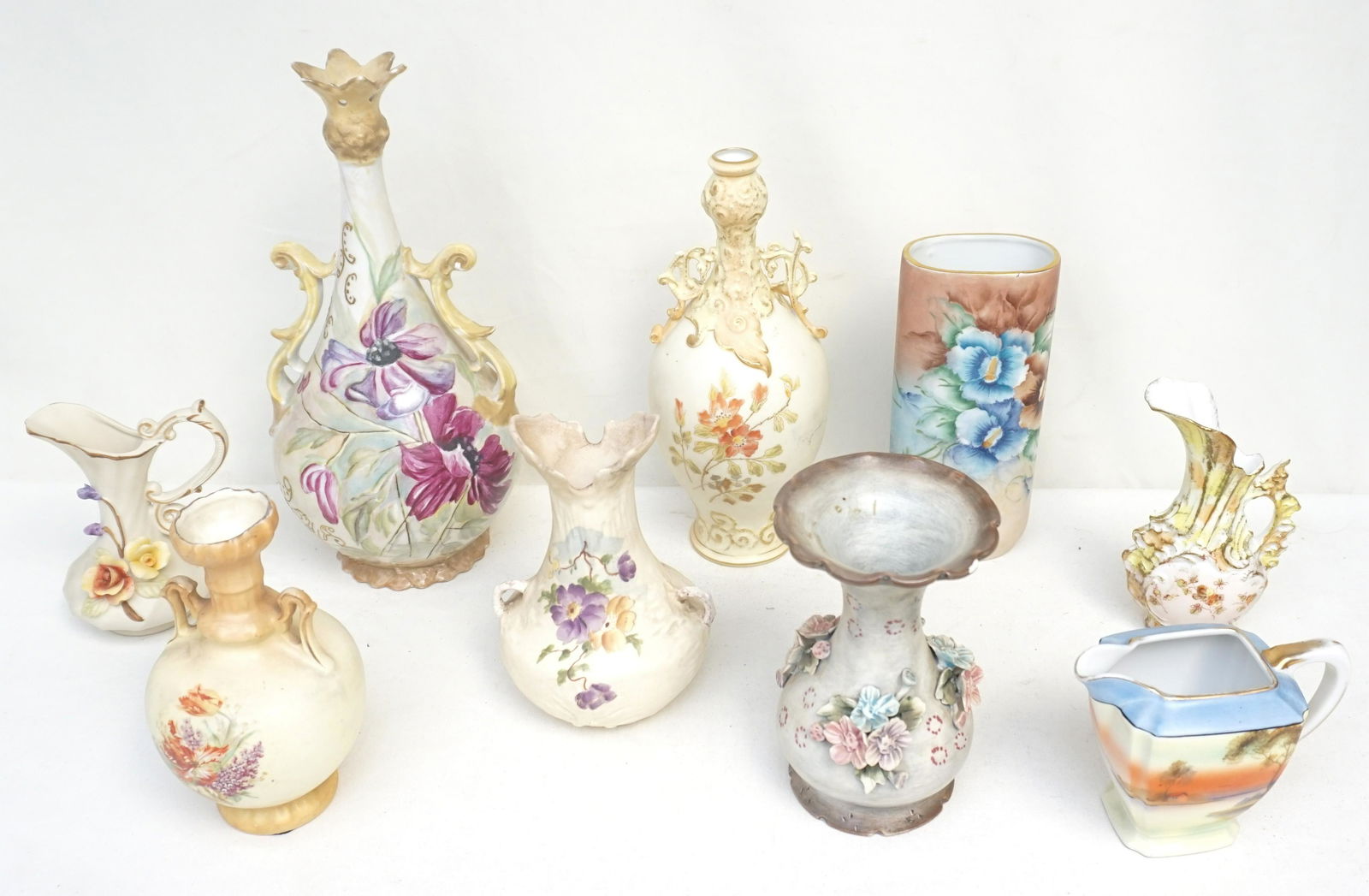 9 pc GROUPING PORCELAIN VASES: 1- Hand Painted Floral Oval Vase 7". 2- Vase with applied flowers, nick to rim, chip to flowers 6". 3- Hand Painted Florals Vase No Marks 11". 4- Rudostaldt Vase Handpained Chip to Ear 9 1/4". 5- Hand
