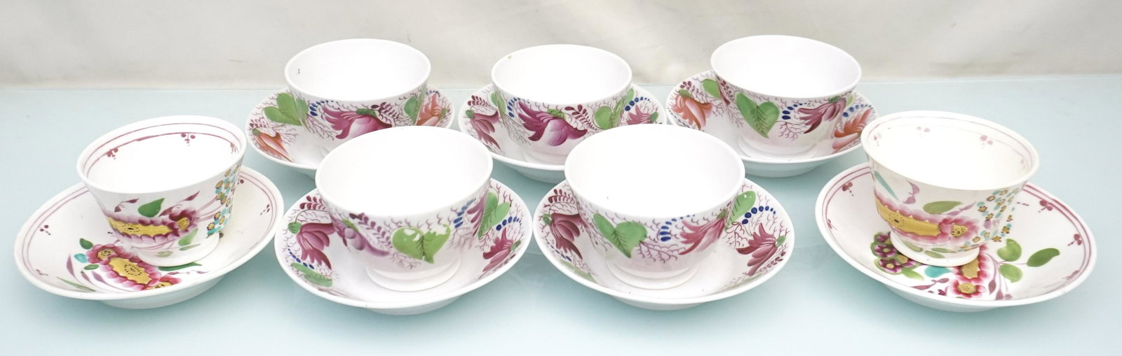 14 PC GAUDY DUTCH TEACUPS & SAUCERS: 14 Piece Gaudy Dutch Teacups and Saucers. All hand painted enamels. 7 Teacups, no handles and 7 Saucer Bowls. Saucers 3 1/2"x2 1/2". Saucers 5 1/4"x1 1/4". Weight on all 3 pds 12 oz. PROVENANCE: A Cha