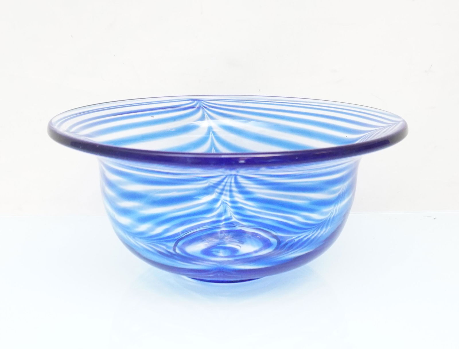 VINTAGE MMA ART GLASS BOWL: Vintage Metropolitan Museum of Art Glass Bowl with Cobalt Blue Pulled Drape Pattern Signed "M". Studio Art Glass. Hand formed glass bowl with blue swirl design. A capital letter M is etched on undersi