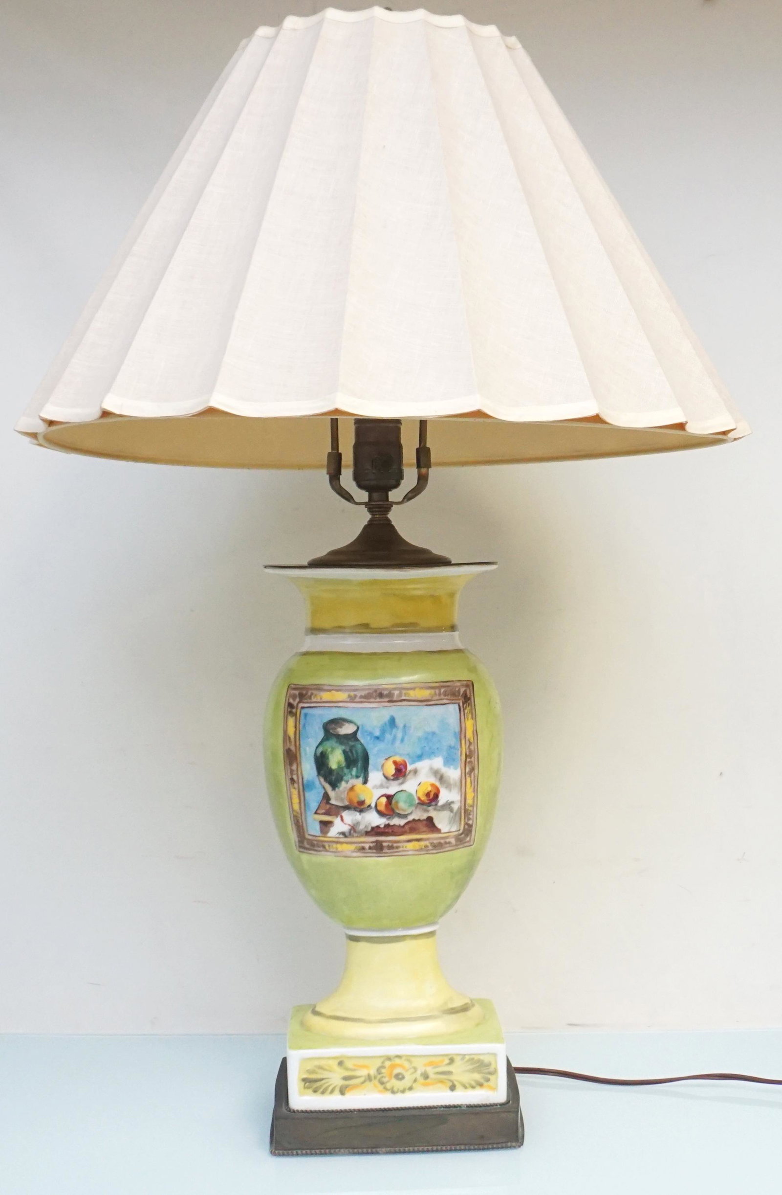 HAND PAINTED PORCELAIN LAMP STILL LIFE: Vintage Hand Painted Decorator Porcelain Lamp. Sponged Green and Yellow with a Still Life. Lamp 6 1/2"x5"x19". Shade 18 1/2"x18 1/2"x11 1/2". Weight 7 pds 10 oz. Shade torn inside. PROVENANCE: A Priva