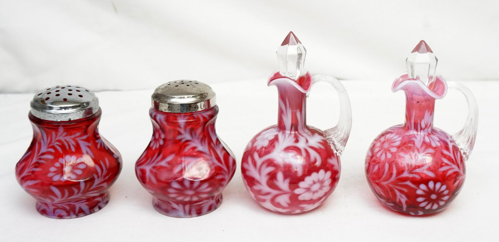 4 pc CRANBERRY OPALESCENT DAISY & FERN SUGAR SHAKERS +: Pair of Vintage 1940s Fenton Cranberry Opalescent Daisy & Fern for L.G. Wright Sugar Shakers #2 Pattern. Each 4 1/4". Good condition, both lids stuck. PAir of Early Fenton for L.G. Wright Cranberry Op