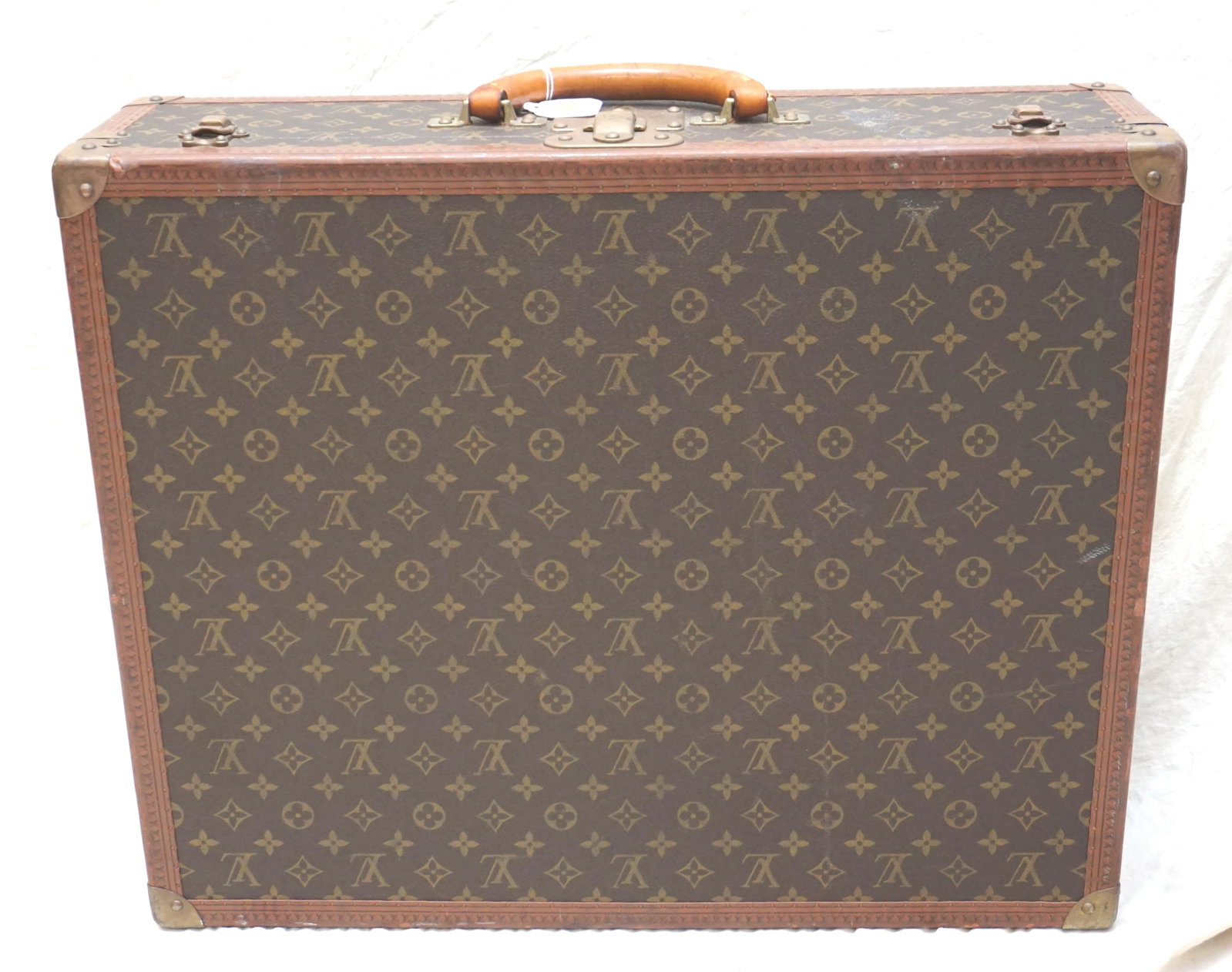 VINTAGE LOUIS VUITTON HARD-SIDED SUITCASE: Louis Vuitton hard-sided garment suitcase, second half of the 20th century, the exterior finished in the famous monogram canvas with brass fittings, interior with fabric straps and shields, original k