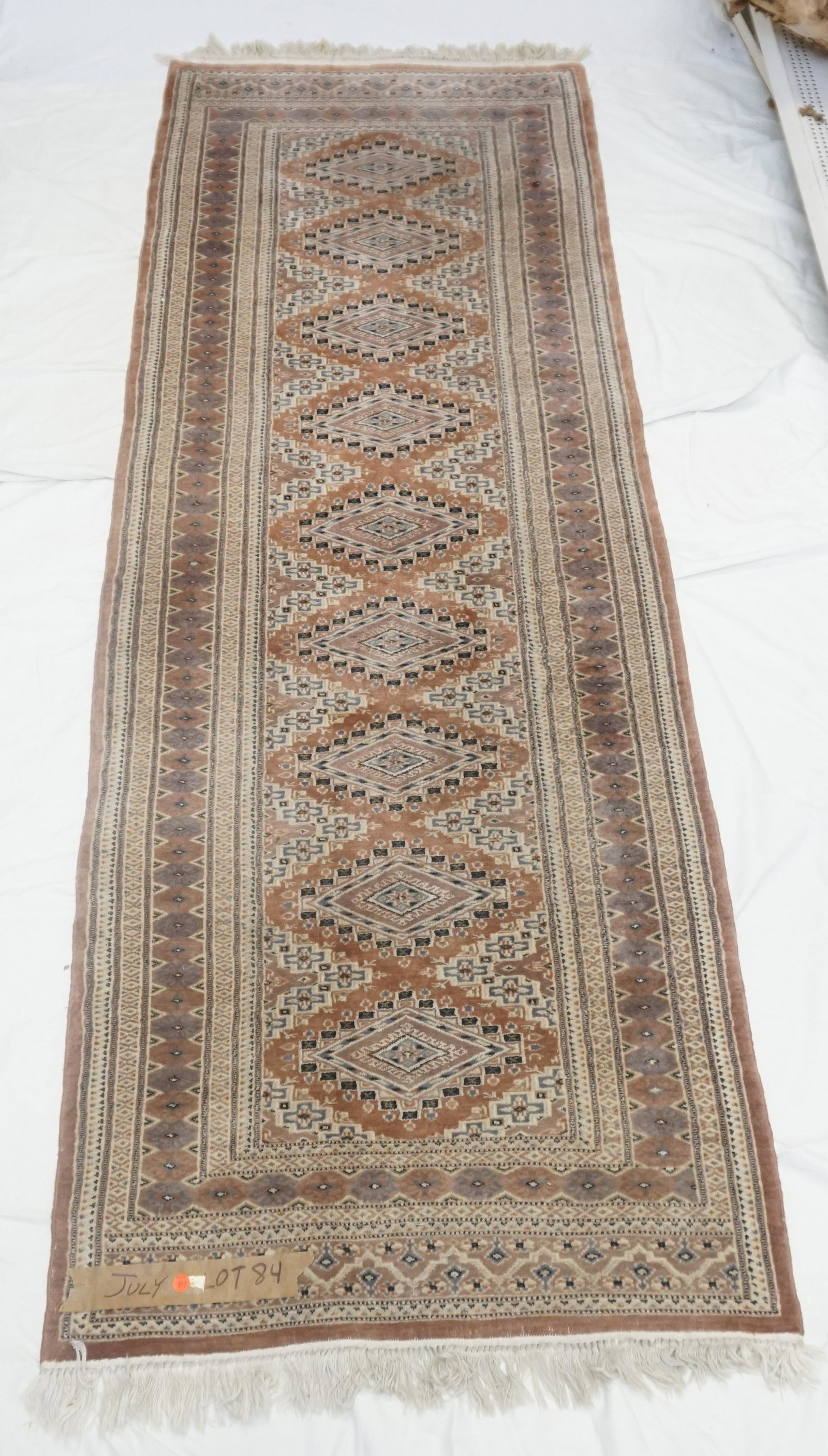 HAND KNOTTED TURKMAN RUNNER 8 FT: Hand Knotted Pakistan 100% wool Turkman Turkoman Runner 8 ft x 2.75 ft. Measures 96"x33" Made exclusivily for Bloomingdales. PROVENANCE: A Private Charleston SC Estate.
