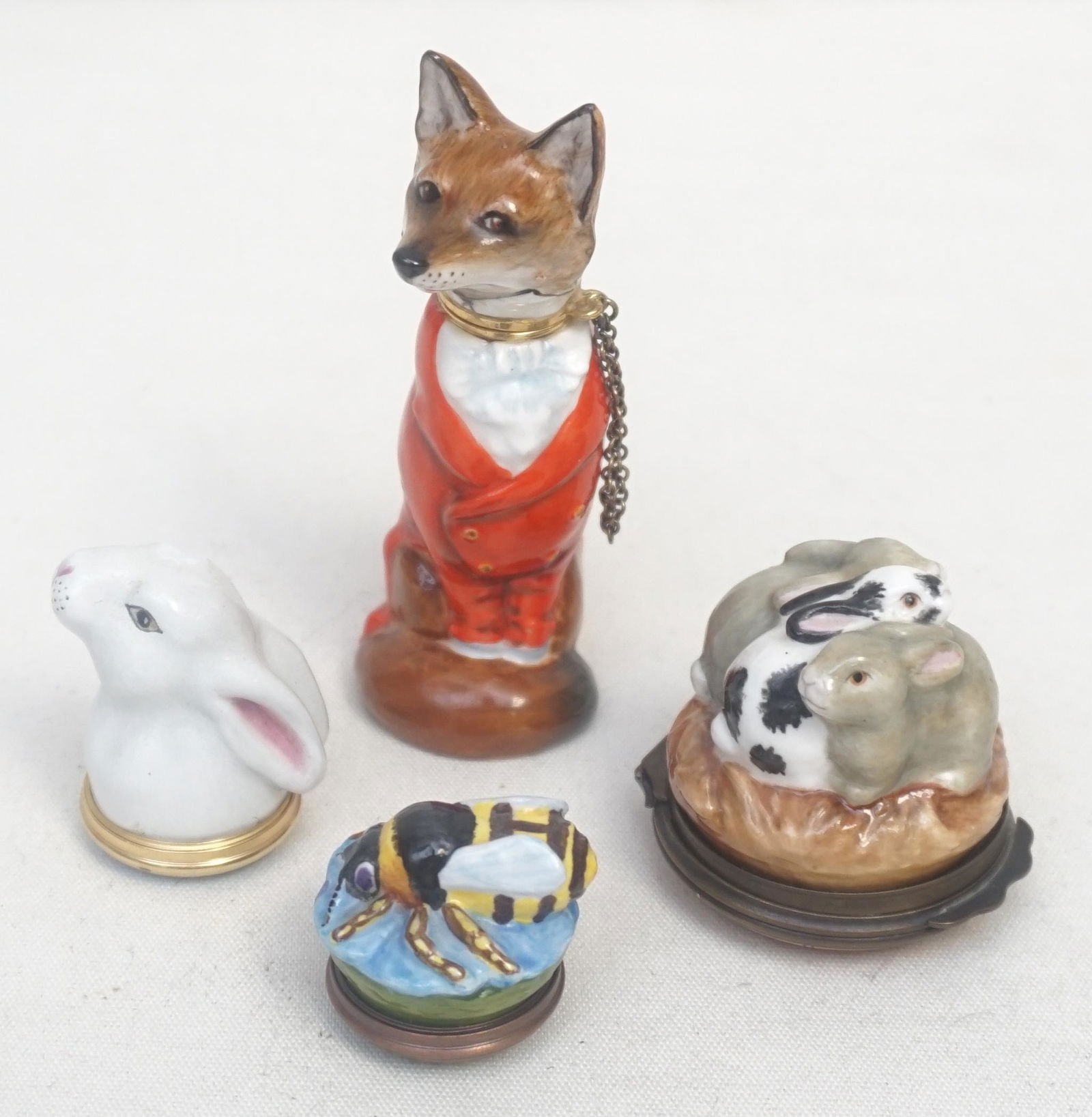 4 pc HALYCON + FIGURAL ANIMAL BOXES: 1- Halcyon Days Rabbit Trio Box. 2- Halcyon Days Rabbit Head Box. 3- Halcyon Days Bee Box. 4- Ashley Fox 3 1/4". All in good condition. Weight 6 oz. PROVENANCE: A Private Charleston SC Estate.