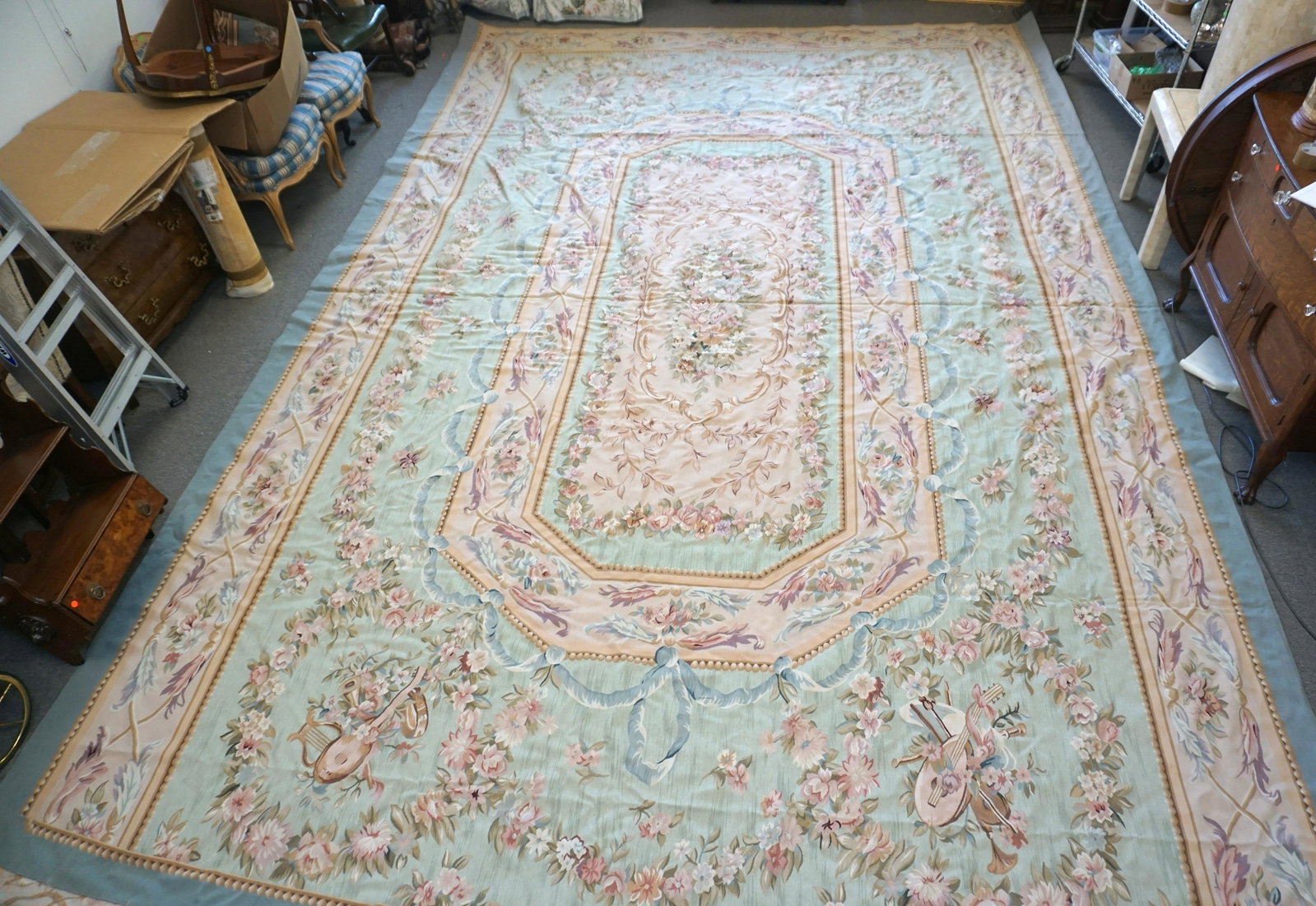 LARGE 19 FT AUBUSSON NEEDLEPOINT RUG: Large Vintage Twentieth century Needlepoint Aubusson Rug. Soft colors of green, blues, pinks and cream. Measures 12'8" x 19'11" (with 5" hem on each side) NO IN HOUSE SHIPPING. PROVENANCE: A Private C