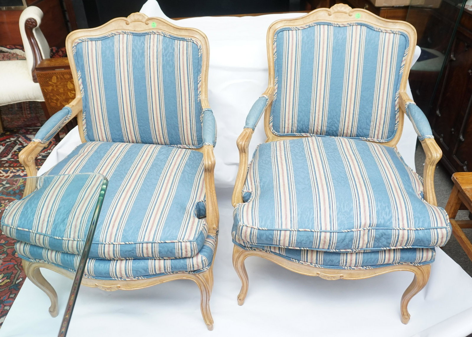 PAIR CARVED UPHOLSTERED ARM CHAIRS: Matched Pair Carved and Upholstered French Style Arm Chairs. Good condition. Measures 22"x16"x37. NO IN HOUSE SHIPPING. PROVENANCE: A Private Charleston SC Estate.***Pickup only or Shipping on this it