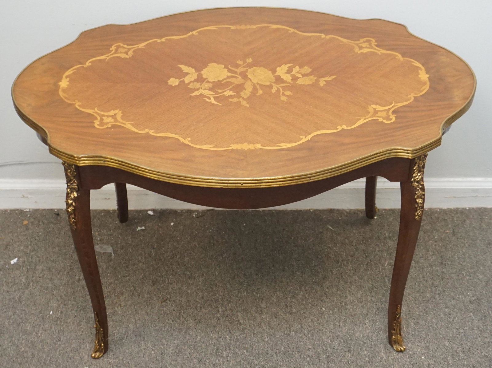 LOUIS XVI STYLE MARQUETRY TABLE: Louis XVI style marquetry table, gilt ormolu mounted mixed wood inlaid. Maesures 32"x22"x20". NO IN HOUSE SHIPPING. PROVENANCE: A Private Charleston SC Estate.***Pickup only or Shipping on this item o