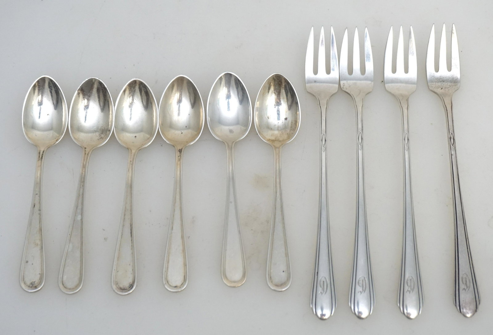 10 PC STERLING OYSTER FORKS & DEMITASSE SPOONS: 1- Four (4) Ladt Diana by Towle Sterling Silver Oyster / Seafood Forks 5 3/4", monogrammed. 2- 6 S. Kirk and Son Sterling Demitasse Spoons. 4 1/4". Approximate Silver Weight 145 grams. PROVENANCE:The 