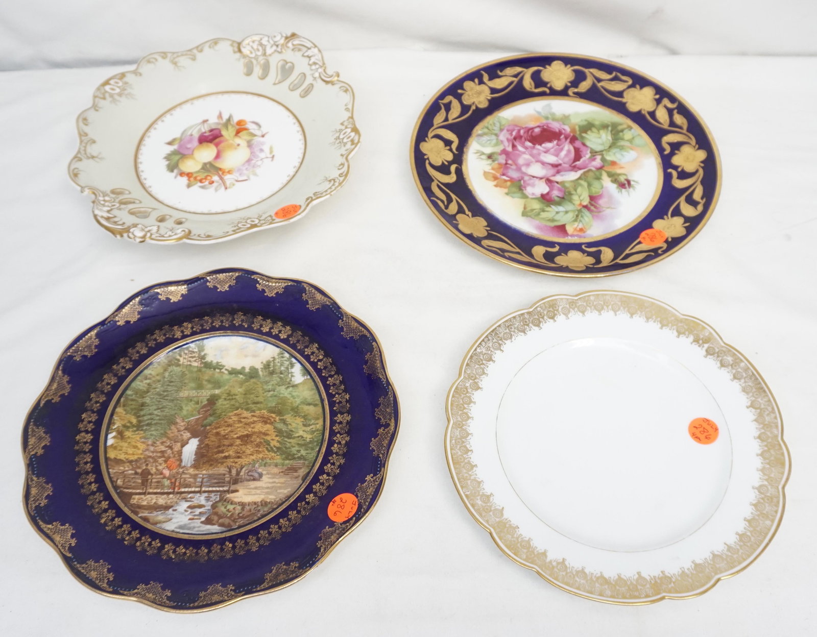 4 ANTIQUE PORCELAIN PLATES INCL ROCKINGHAM: 4 Antique and Vintage Plates. 1- Rockingham Footed Fruit Dish 9 1/4". 2- Rose Transfer with cobalt and gilt rim 9 1/2'. 3- Limoges Waterfall Pictorial Plate with cobalt and gilt rim 9 1/4". 4- White S