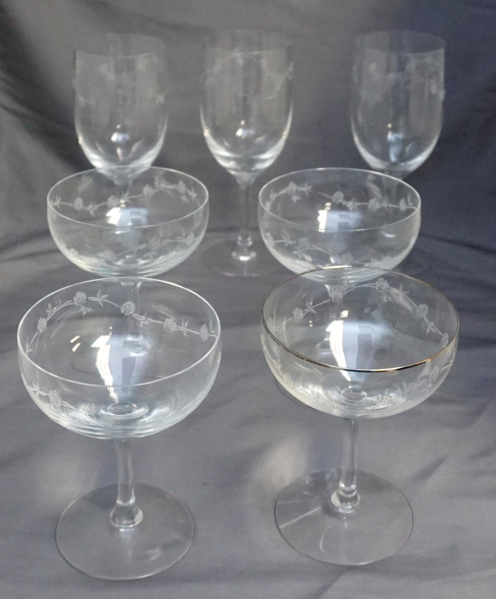 7 FOSTORIA GARLAND ETCHED GLASSES: 8 Fostoria Etched Garland Glasses. 4 Champagnes, 1 with Platinum Rim 5 1/8" and 3 Water Goblets 7". Weight on all combined 3 pds. PROVENANCE: A Private Charleston SC Estate.