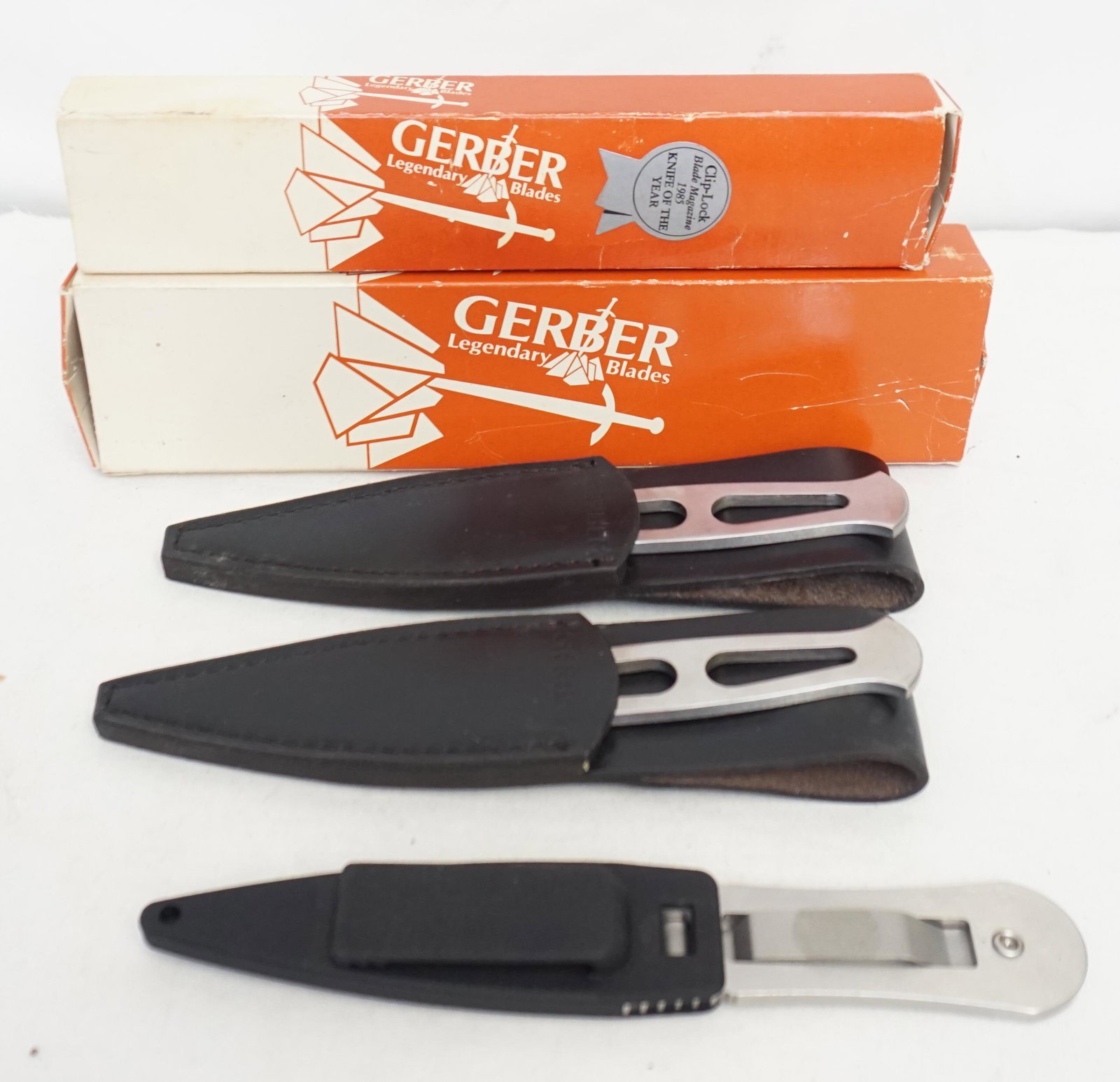 3 VINTAGE GERBER SURVIVAL KNIVES: 1- Model 5301 Gerber Survival Knife by Blackie Collins. 1985 Knife of the Year. In Original Box.This vintage knife is in outstanding all original condition, with absolutely no signs of use. This is a 