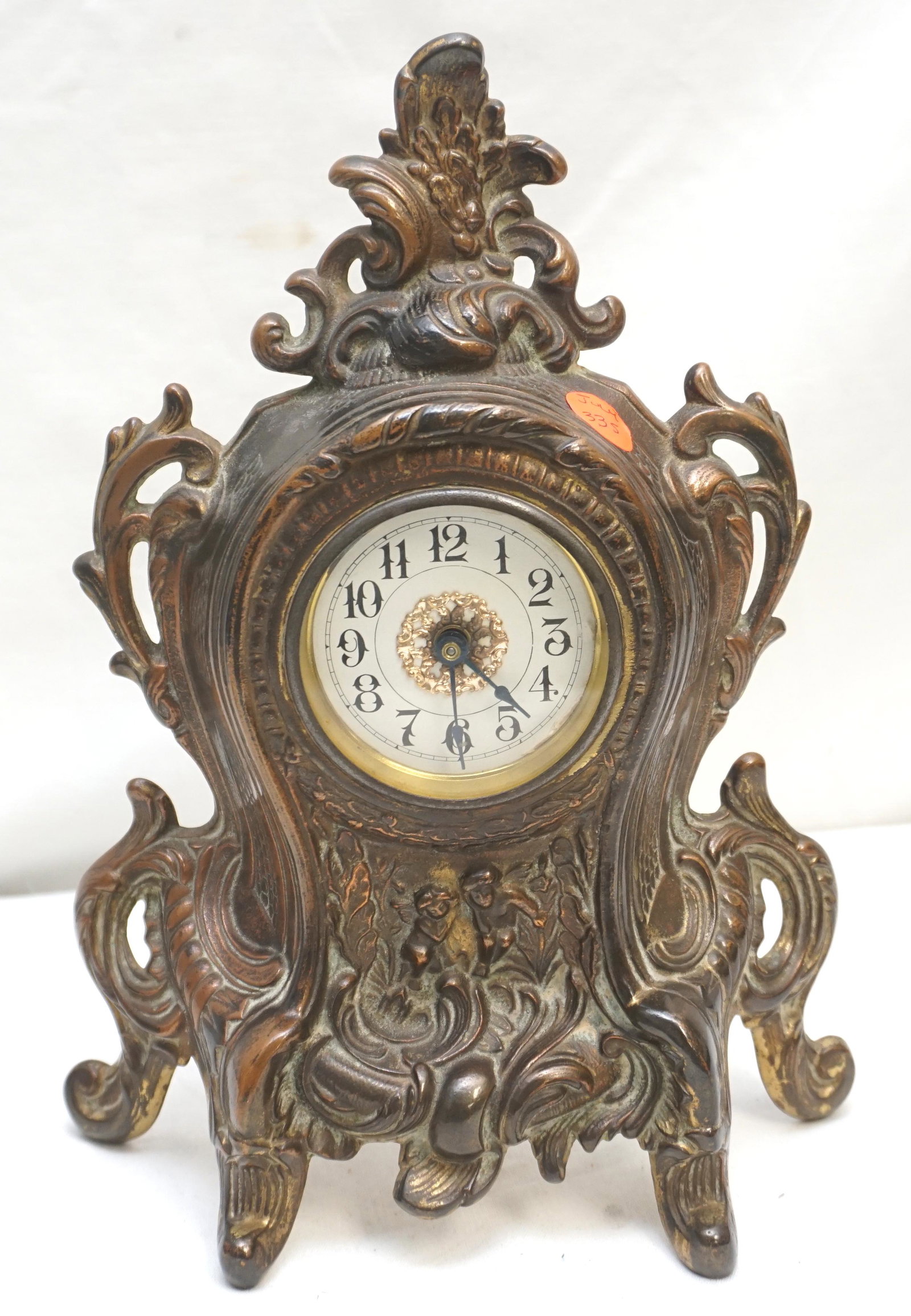 ORNATE ANTIQUE MANTEL CLOCK: Antique c. 1906 Ornate Gilded Iron Mantel Clock. Made in the USA. Clock is not running. Measures 8"x3"x10 3/4". Weight 3 pds 11 oz. NO IN HOUSE SHIPPING. PROVENANCE: A Private Charleston SC Estate.***