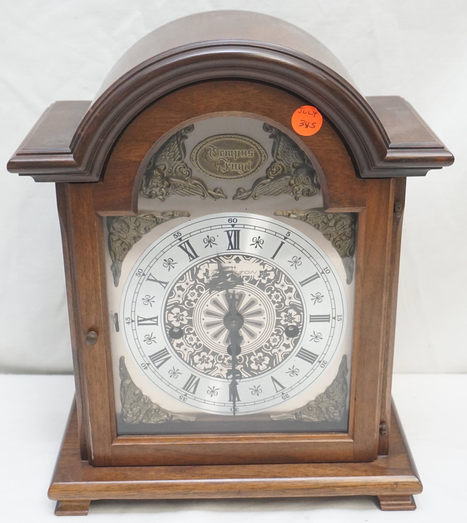 VINTAGE 1970S HAMILTON TEMPUS FUGIT MANTEL CLOCK: Vintage 1970s Hamilton Tempus Fugit Clock with Key. Walnut Case. Movement made in West Germany. Not running. Measures 10 1/2"x5 3/4"x13 1/2". Weight 6 pds. NO IN HOUSE SHIPPING. PROVENANCE: A Private 