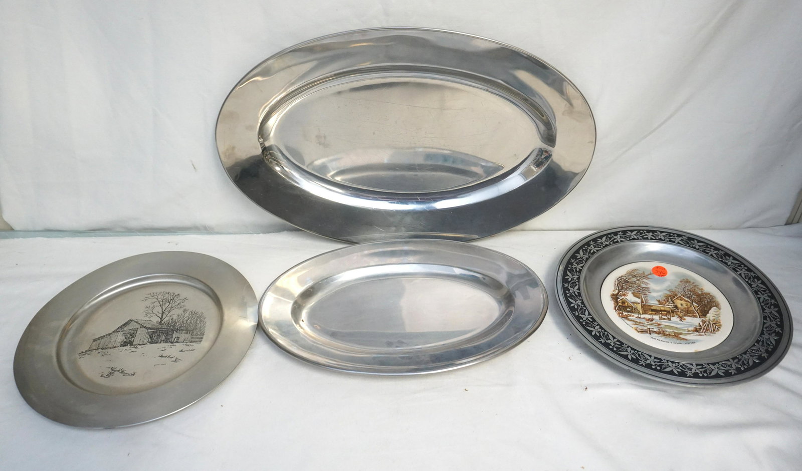 4 PC PEWTER & STAINLESS PLATES & PLATTERS: 1- Williamsport Foundry in Canton, Ohio Pewter & Porcelain Plate 10 3/4". 2- Darell Koons 1972 Pewter Plate 11" 3& 4-Stailess Steel Platters 19"and 14". Weight on all 6 pds 10 oz.
