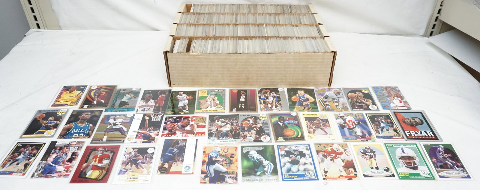 1980-1990's BASKETBALL & FOOTBALL ROOKIE CARDS: Large lot of mostly 1989-1995 NBA and NFL rookie player cards in protected sleeves. Star rookie players include Bo Jackson, Gary Payton, Chris Webber, Jason Kidd and more. Inhouse shipping not guarant