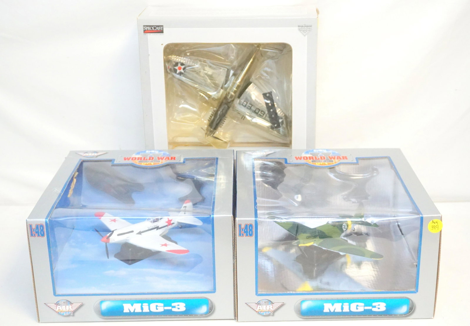 YAT MING MILITARY DIECAST AIRCRAFTS: Two 1:48 diecast Yat Ming MiG-3 aircrafts and one SpecCast Limited Edition P-40 Warhawk plane. Loose parts to the P-40 warhawk due to age. All are unopened in original boxes.